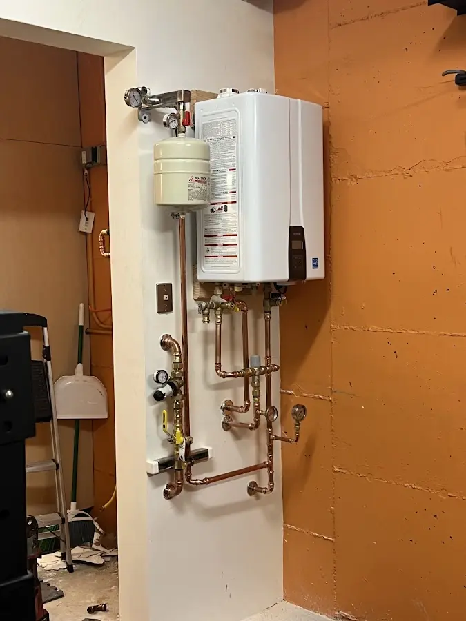 Plumbing technician inspecting water heater connections in Secaucus